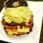 Cajun double cheeseburger with bacon, chipotle aioli avocado mash, on top of a portabello bun